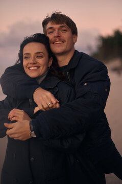 Portrait of a happy couple  in love on a windy beach