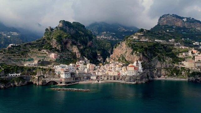 Aerial wide angle front view of Amalfi cinematic drone footage of old village picturesque European travel holiday destination in south Italy
