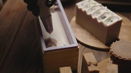 The master soapmaker is decorating natural handmade berry soap. Natural cosmetics. The process of making soap in the workshop