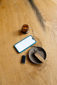 A mobile phone with white screen on the table