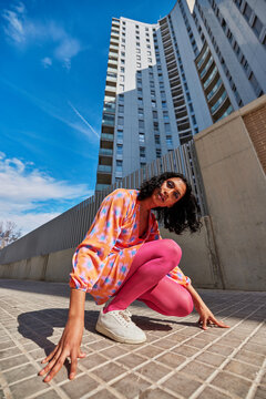 Bright woman on pavement in city