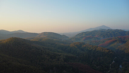 Beautiful sunrise on the mountain with fog in winter. The sun shines down on a serene mountain...