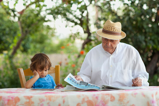 Generational Contrast: Grandfather and Grandson Together
