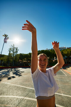 Happy fitness woman shooting a three-pointer
