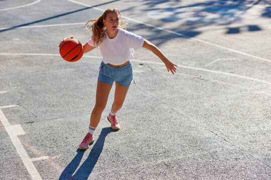 Young woman with basketball ball
