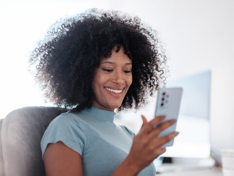 Smiling Woman Enjoying Using Phone While Sitting in Office