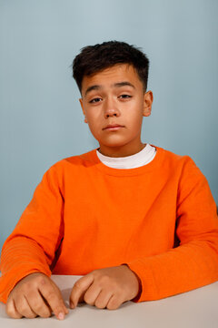 Young boy in an orange sweater 