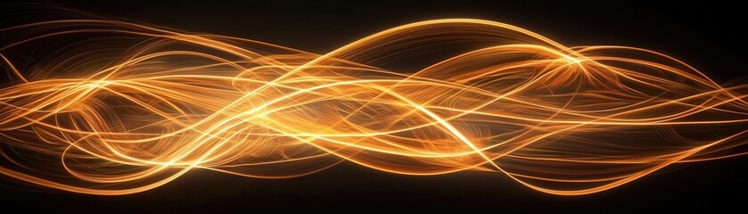Obraz premium A mesmerizing display of golden light trails flowing gracefully across a dark background, creating a sense of movement and energy.