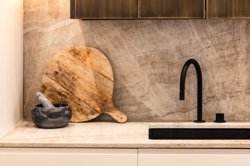 Minimalist kitchen with black faucet and rustic elements