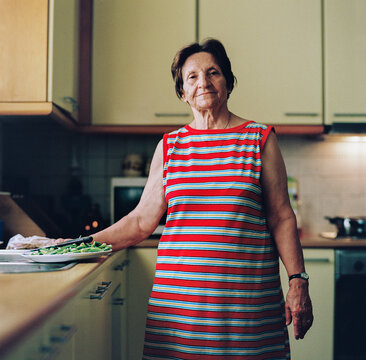 Senior woman preparing food in a bright kitchen during daytime