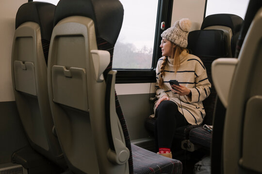 Woman looking through train window