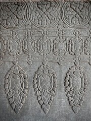 Cambodia, Siem Reap - patterns carved into a stone wall by the ancient Khmers on the grounds of the Angkor Wat temple