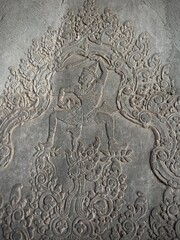 Cambodia, Siem Reap - patterns carved into a stone wall by the ancient Khmers on the grounds of the Angkor Wat temple
