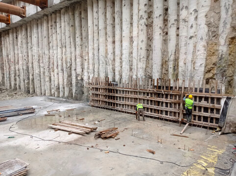 multiple workers install rebar reinforcements