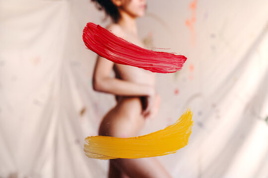 Artsy naked woman with paint strokes