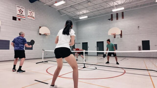 Smooth shot of pickleball game in gym