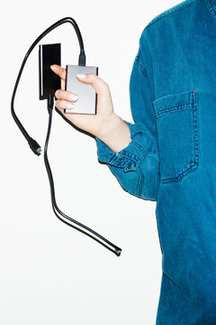 Person holding devices hardware, hard disks in office workplace 
