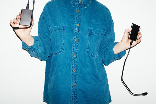 Person holding devices hardware, hard disks in office workplace 