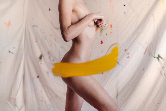Artsy naked woman with paint strokes
