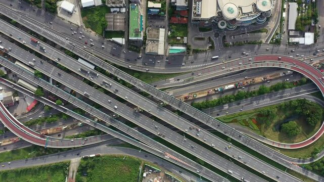 Aerial top View of busy freeway, rush hour heavy traffic jam highway. Aerial view of multiple roads in city, vehicular intersection, expressway with important infrastructure in the morning.