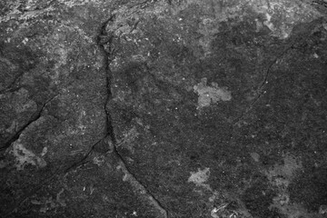 Black grey rock texture. Rough mountain surface with cracks. Close-up. Dark stone background with space for design Grunge Banner Wide