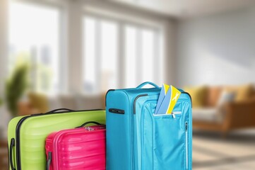 Interior of hotel room with colored travel suitcase