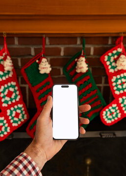 Blank Screen mobile phone hand Christmas Stockings mantle