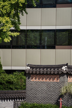 Traditional Korean architecture wall and modern building wall behind 