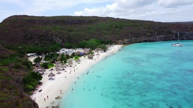 Establishing Aerial of Overcast Beach with Greenery and Parking Lot