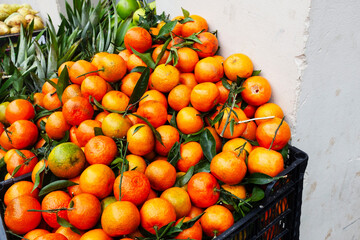 Fresh juicy delicious oranges in basket in a urban city environement 