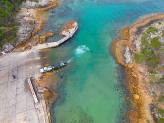 Car and trailor on coastal boat ramp