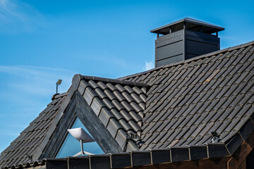Building with black roof featuring Starlink satellite mounted on top