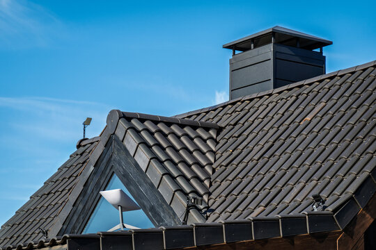 Building with black roof featuring Starlink satellite mounted on top
