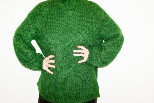 Person with green cozy soft wool sweater pullover with hard flash