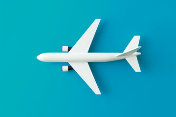 Fototapeta premium Flat lay design of a white plane isolated on a colorful background