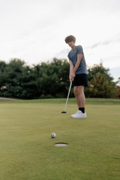 Teenage boy golfing