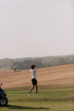 Teenage boy golfing