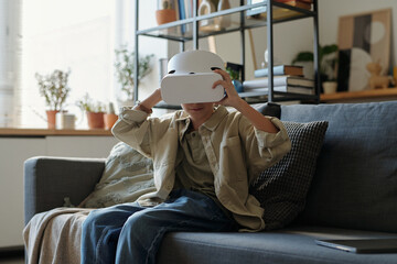 Young Boy Using VR Glasses when Playing Video Games at Home
