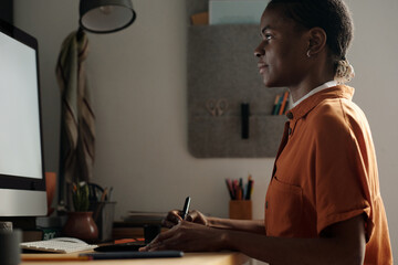 Female Graphic Designer Using Smart Devices for Work at Home Desk