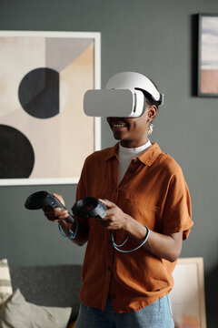 Woman in VR Glasses Playing Video Games at Home