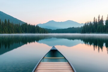 Serene Canoe on Calm Lake Surrounded by Majestic Mountains at Dawn