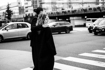 Couple walking together at a city crosswalk