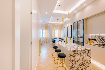 Modern kitchen with marble island and gold accents