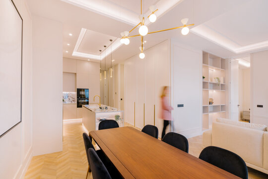 Modern open-concept kitchen and dining area with warm lighting