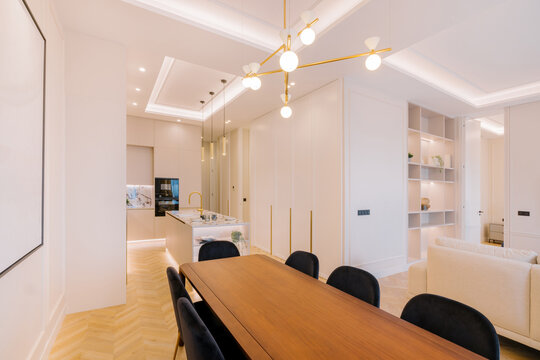 Modern dining room and kitchen with elegant lighting