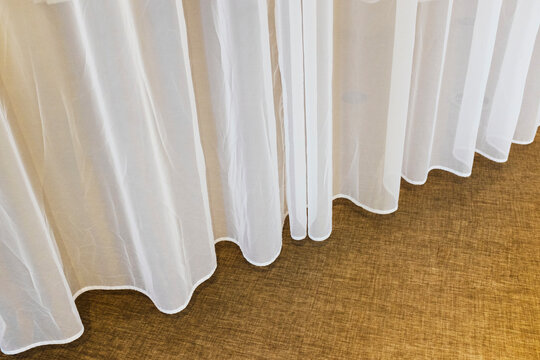 Close-up of white fabric textile curtain with soft lighting 