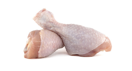 Two raw chicken drumsticks resting on a white background