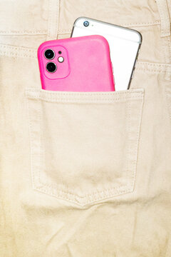 Multiple smartphones in pocket of denim jeans with hard direct flash