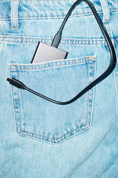Harware device in pocket of blue denim jeans with hard direct flash