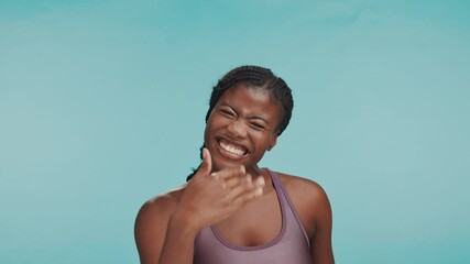 Happy woman, fitness and face in studio with pointing, sports announcement and personal trainer. Black person, excited and calling you on blue background space for gym sign up promotion or membership